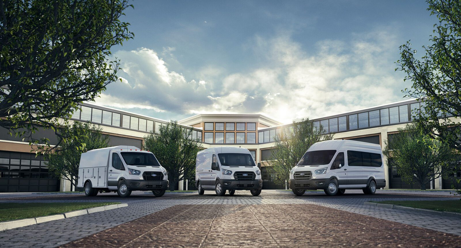 Three white Ford Transit vans parked in front of a modern building for Nextran